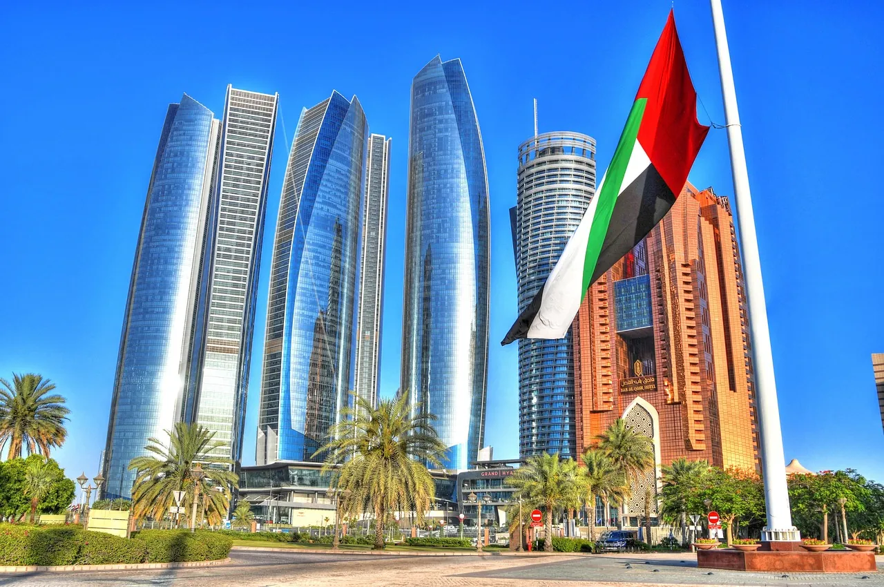 Abu Dhabi towers with the UAE flag flying in front