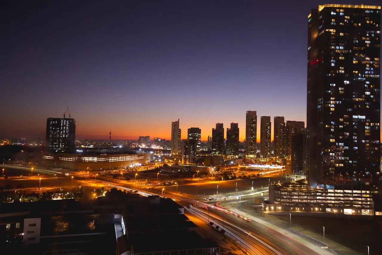 Abu Dhabi at dusk, with lit towers and busy roads