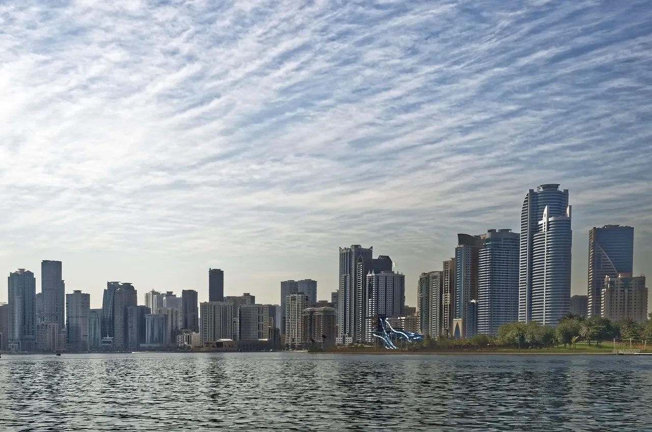 The Sharjah skyline across Khalid Lagoon under a streaked sky