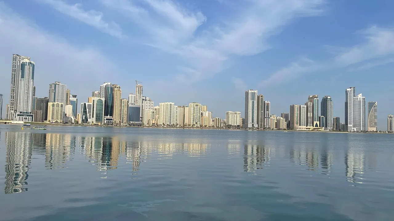 The Sharjah skyline reflected in the lagoon on a clear morning